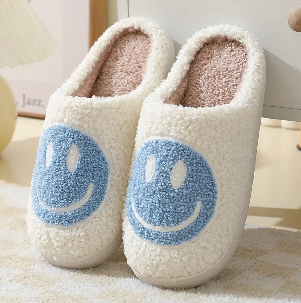 Indulge in the cuteness and charm of our Plush Happy Face Slippers. Made from high quality boucle fabric, these luxuriously soft slippers are the epitome of comfort. With their heartwarming design, walking around the house will feel like a dream. Say goodbye to cold feet and hello to cozy luxury.