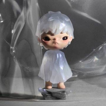 Small figurine with a white outfit and transparent hood on a reflective surface