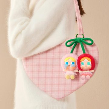 The Pop Mart Crybaby Crying For Love Series Vinyl Face Cherries figure is a finely detailed collectible that embodies emotional expression through its unique design.