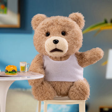 Teddy bear sitting at a table with a drink and food, against a blurred indoor background