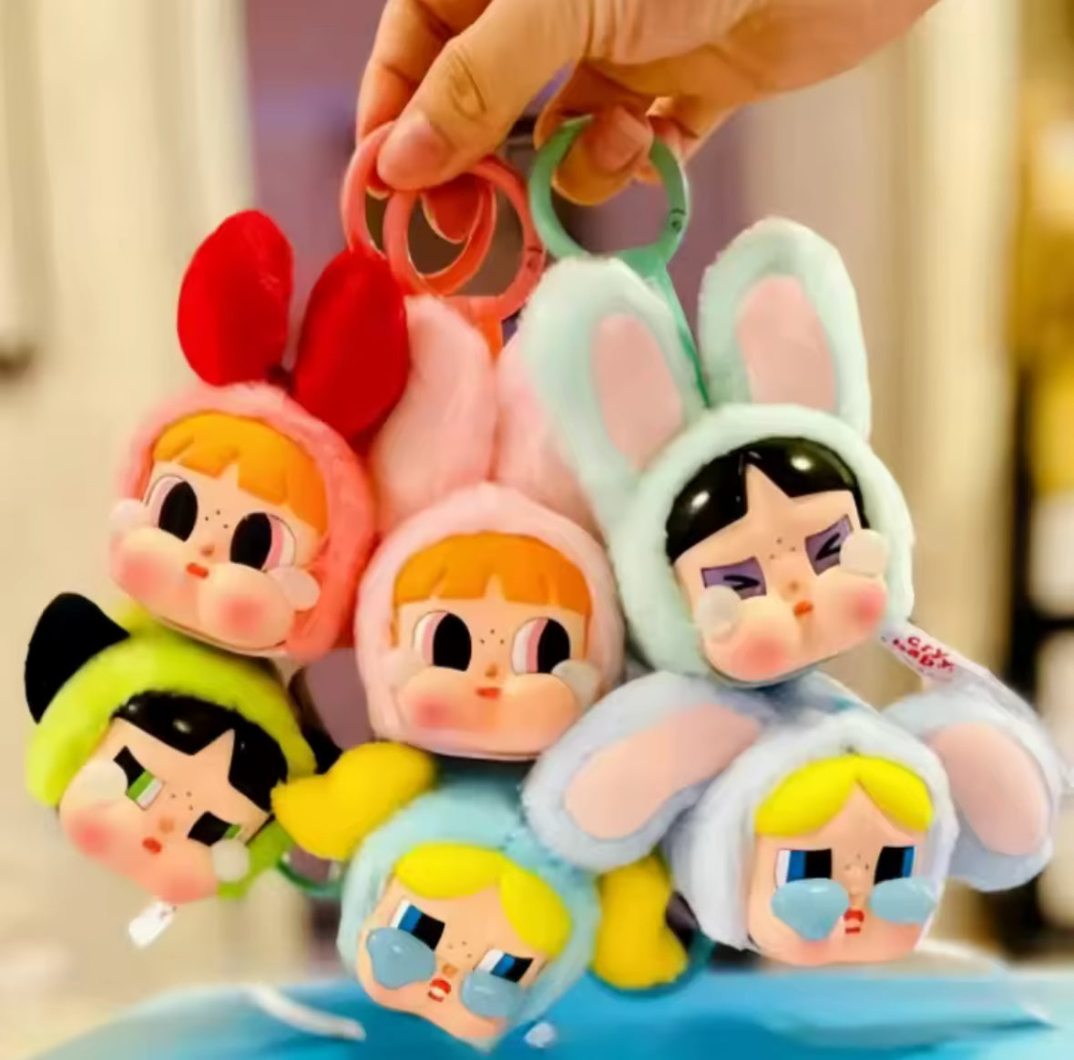 Introducing the Pop Mart Powerpuff Girls Cry Baby Series! Each blind box features a vinyl faced plush bag pendant doll.