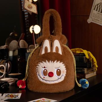 Plush bag with a face design on a dark surface