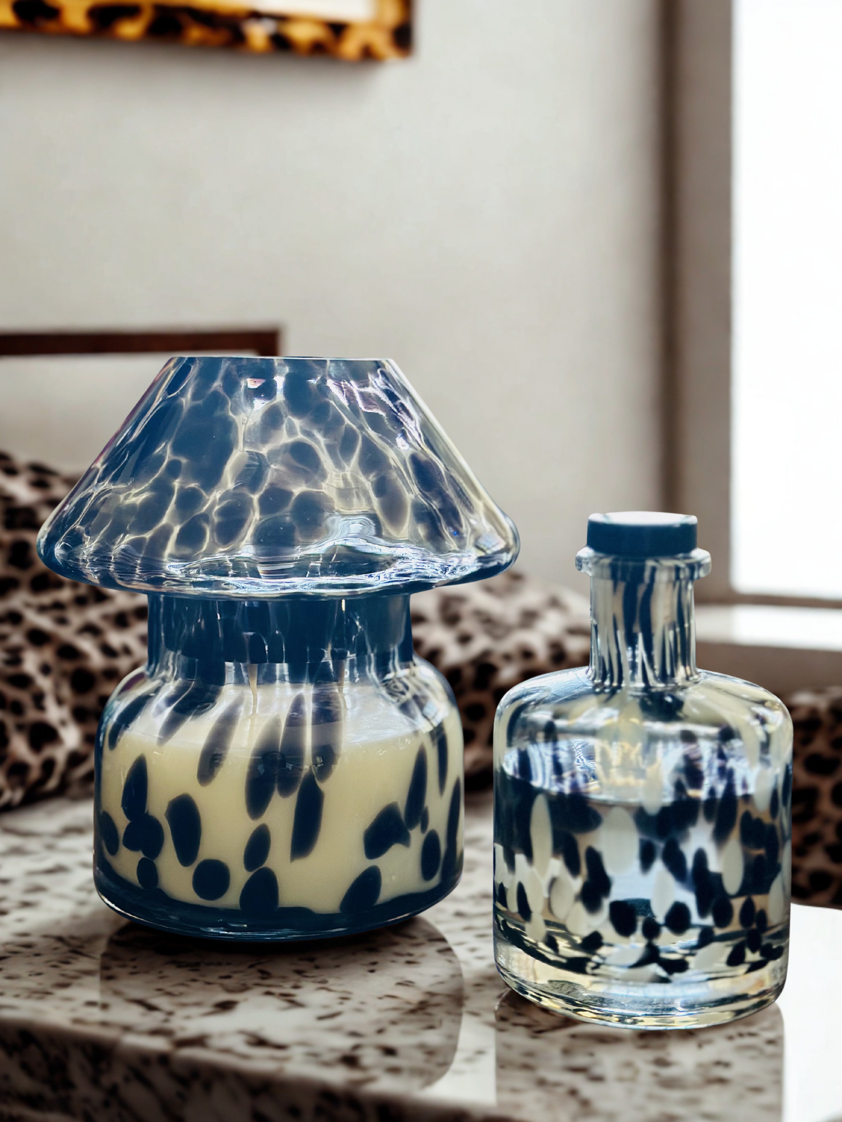 Two glass containers with black and white pattern on the glass.