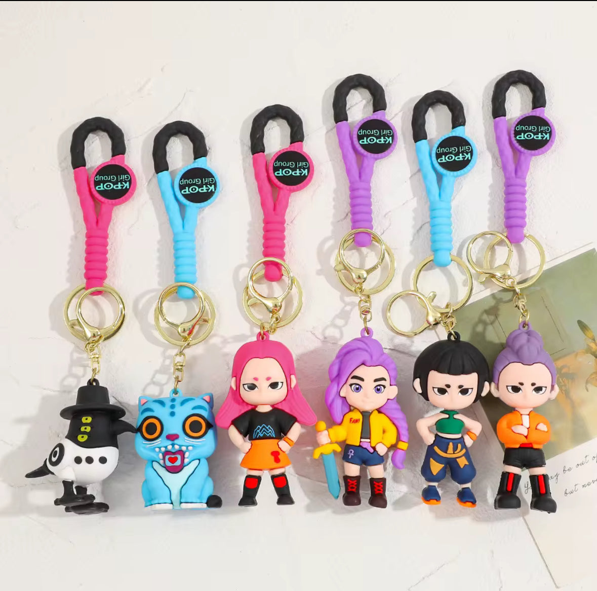 Set of colorful keychains with cartoon characters on a white background