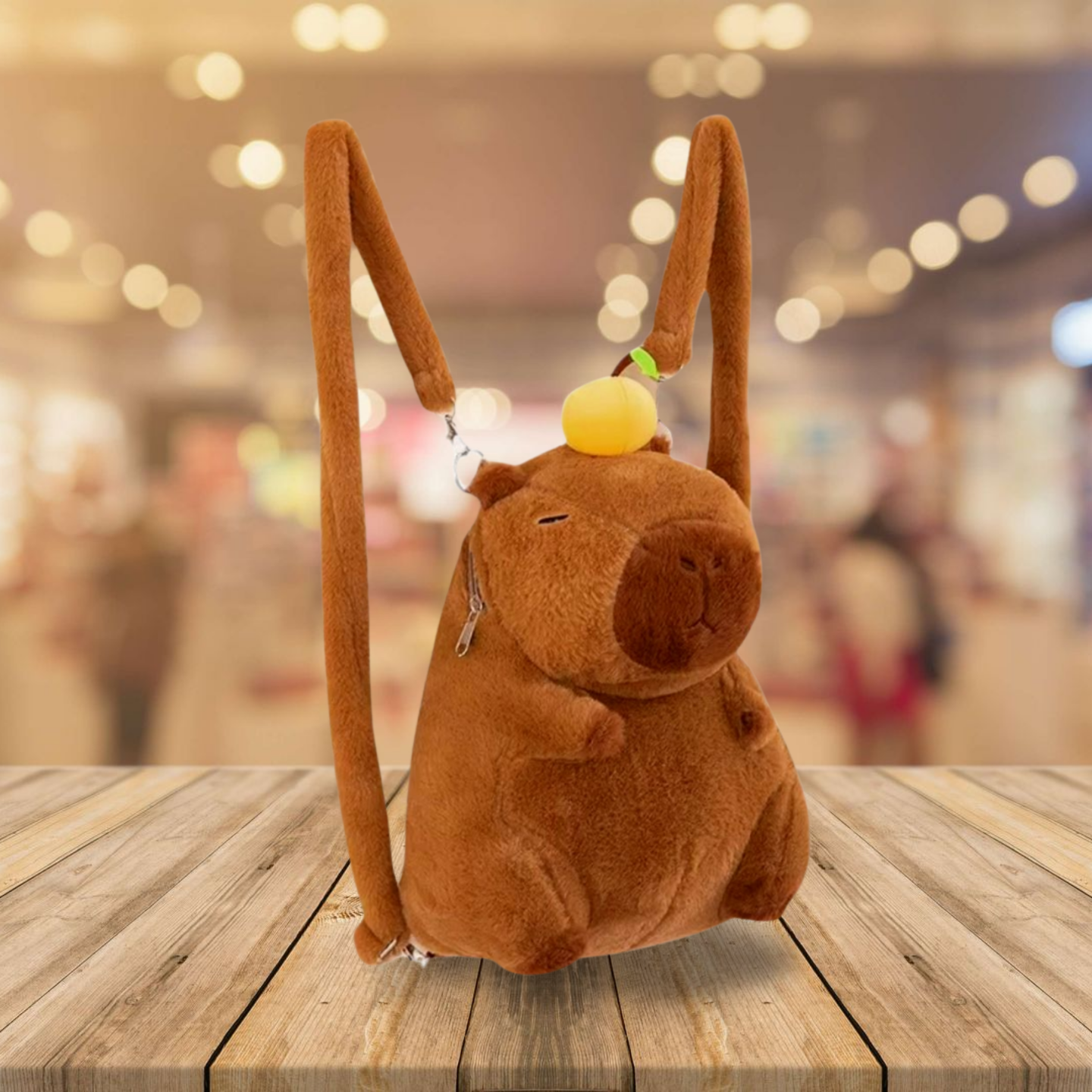 Brown plush bag shaped like a capybara character on a wooden surface with a blurred background
