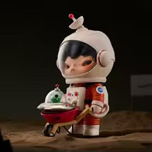 Figurine of a child in an astronaut suit on a dark background
