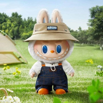 The doll's body showcases white plush fur on the arms, head, and ears, while the face and hands are crafted from vinyl. Notable facial features include large blue eyes and a broad grin revealing pointed teeth