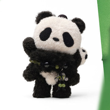 Plush panda toy with a green ribbon on a white background