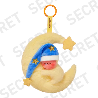 Plush toy resembling a crescent moon with a star and blue hat on a white background