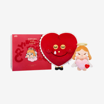 Red heart-shaped plush toy with cartoon characters on a white background