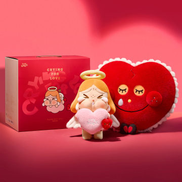 Two plush toys and a box with 'Crying for Love' text on a pink background