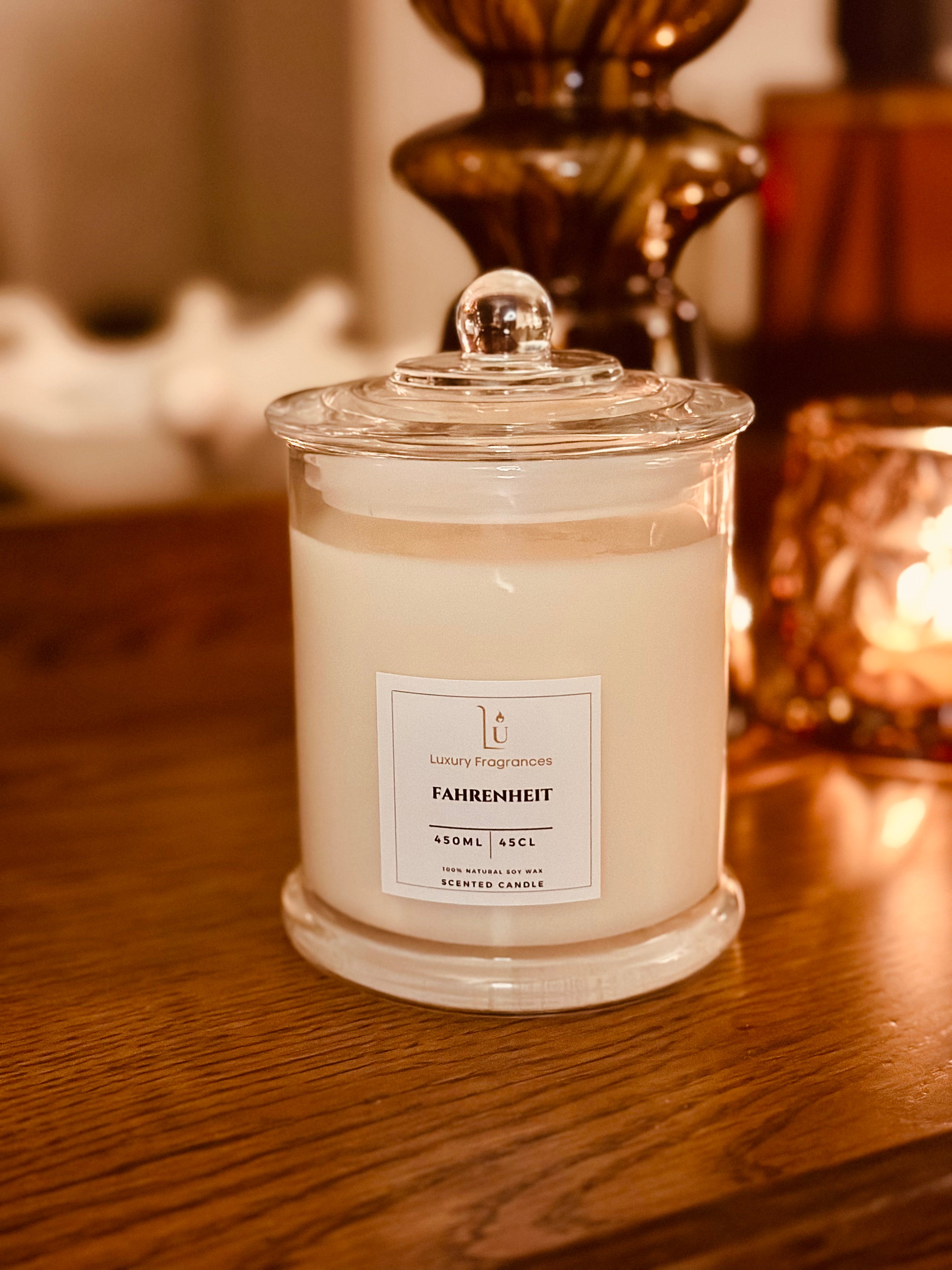Scented Candle in a glass jar with a label on a wooden surface.