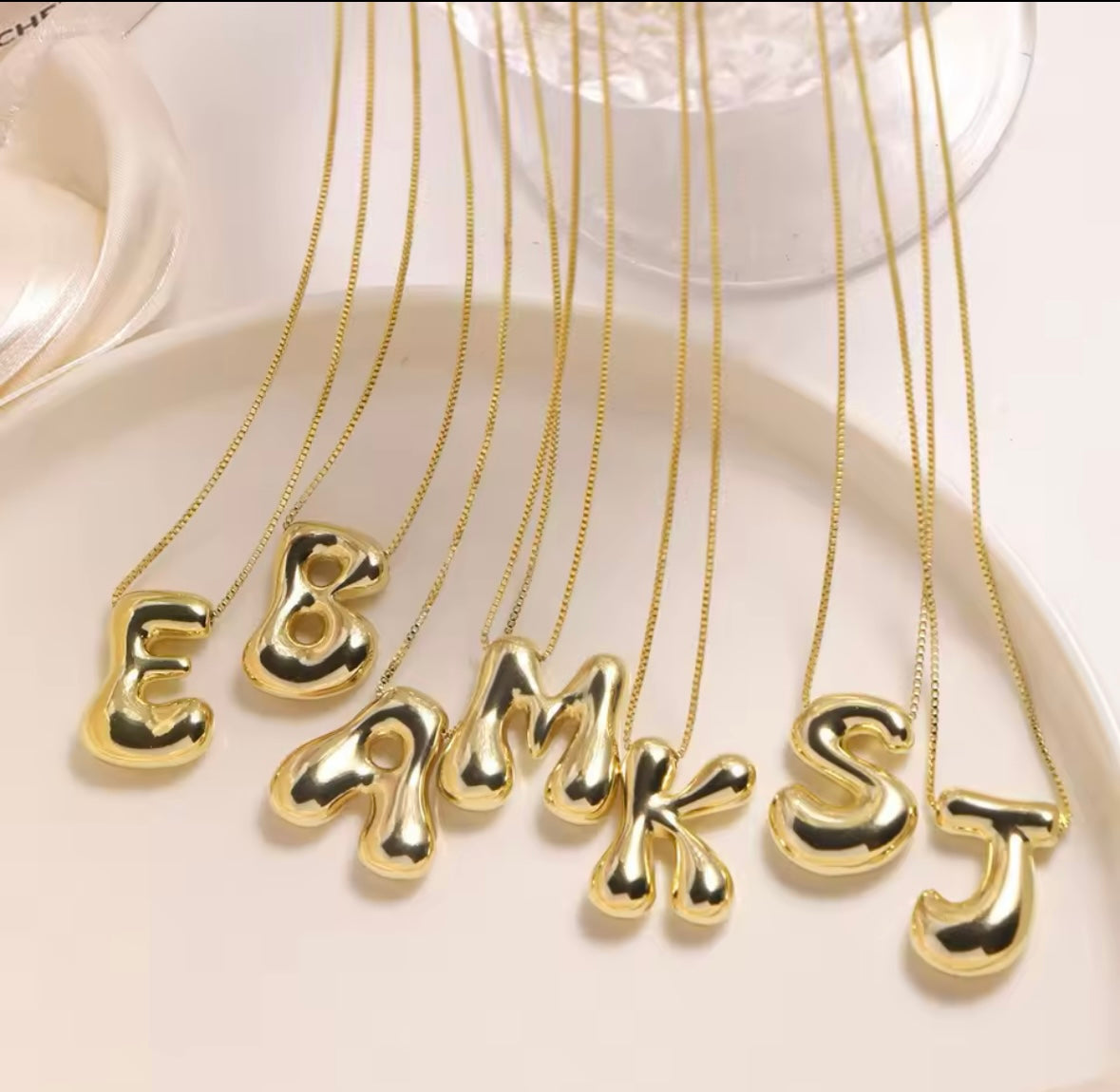 This elegant Gold-Plated Bubble Letter Monogram Necklace adds a personalised touch to any outfit.

Expertly crafted with a sleek gold-plated finish, this necklace features a bold and eye-catching monogram letter design. Elevate your style and stand out with this unique and sophisticated accessory.