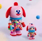 Collection of colorful toys including a dog figurine, a pink character, and a blue ball on a white background.