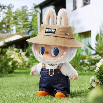  Embracing a "wild" theme, this figure stands nearly 16 inches tall and is dressed in denim overalls layered over a white t-shirt. It is accessorised with work boots and a brown bucket hat featuring "The Monsters" emblem. 
