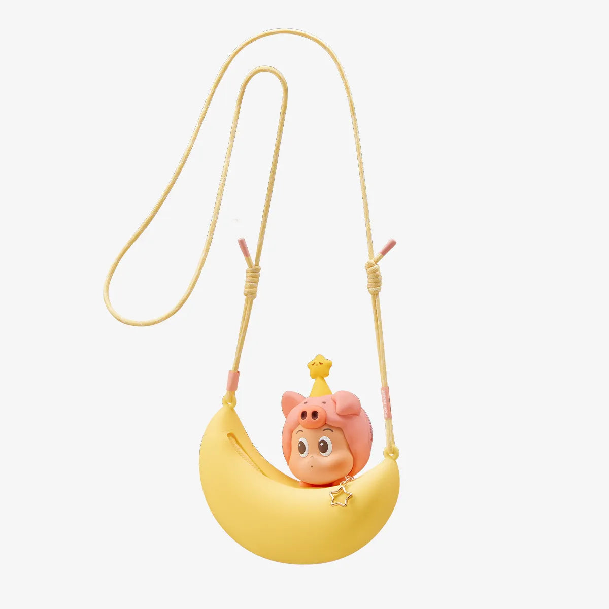 Cute character figurine on a yellow crescent moon with a yellow string on a light pink background