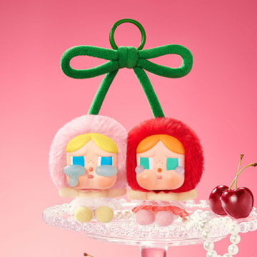The Pop Mart Crybaby Crying For Love Series Vinyl Face Cherries figure is a finely detailed collectible that embodies emotional expression through its unique design.