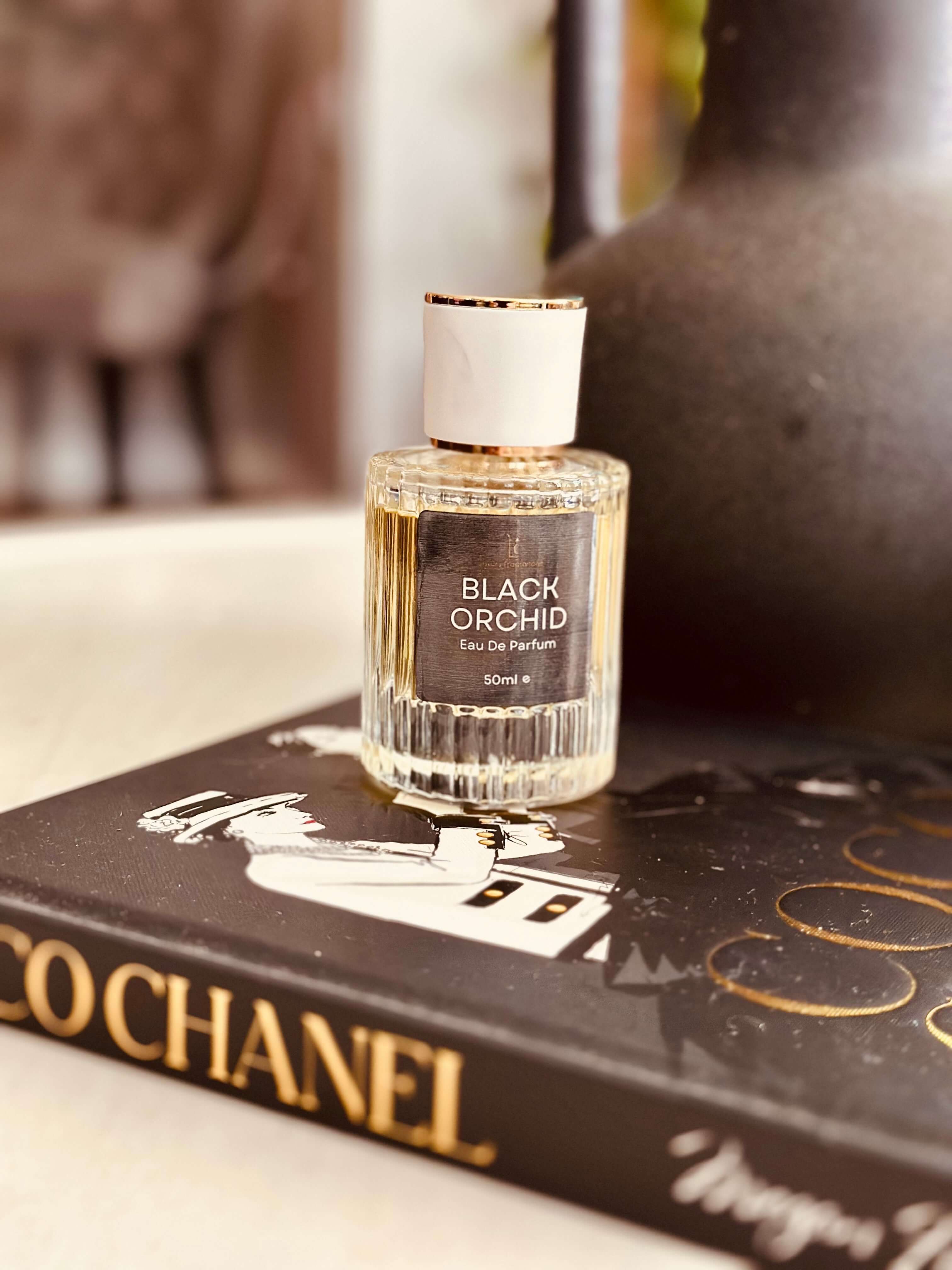 Black Truffle & Patchouli Eau de Parfum by LU Fragrances - 50ml ribbed glass bottle on a Coco Chanel coffee table book, Tom Ford Black Orchid type

