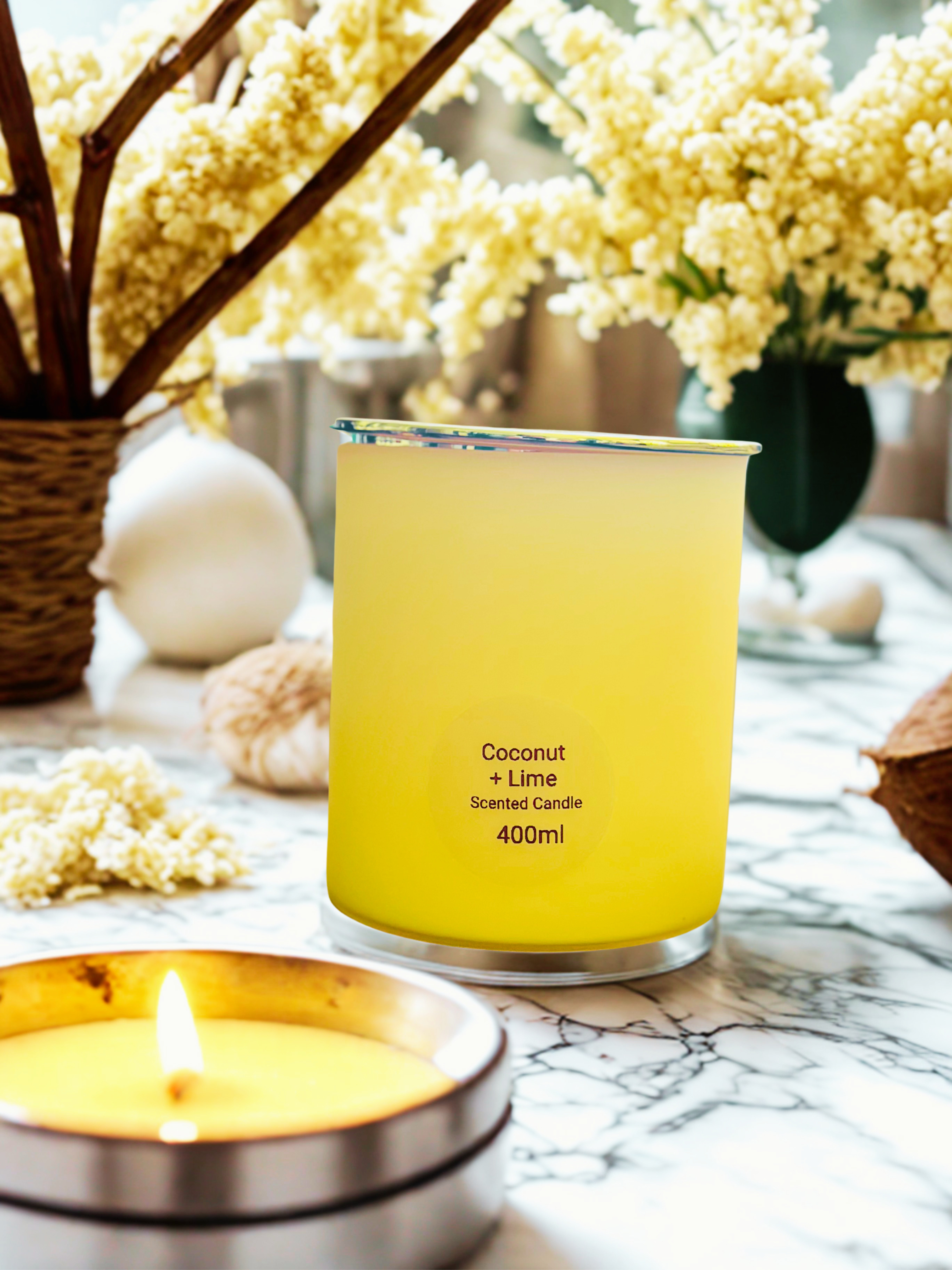 Pastel lemon coloured scented candle on a clean fresh setting.