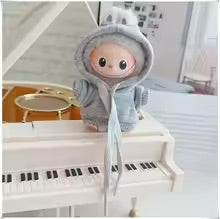 Plush toy with a Grey hoodie in front of a piano