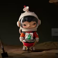 Small figurine of a character in an astronaut suit holding a green alien figure on a dark background