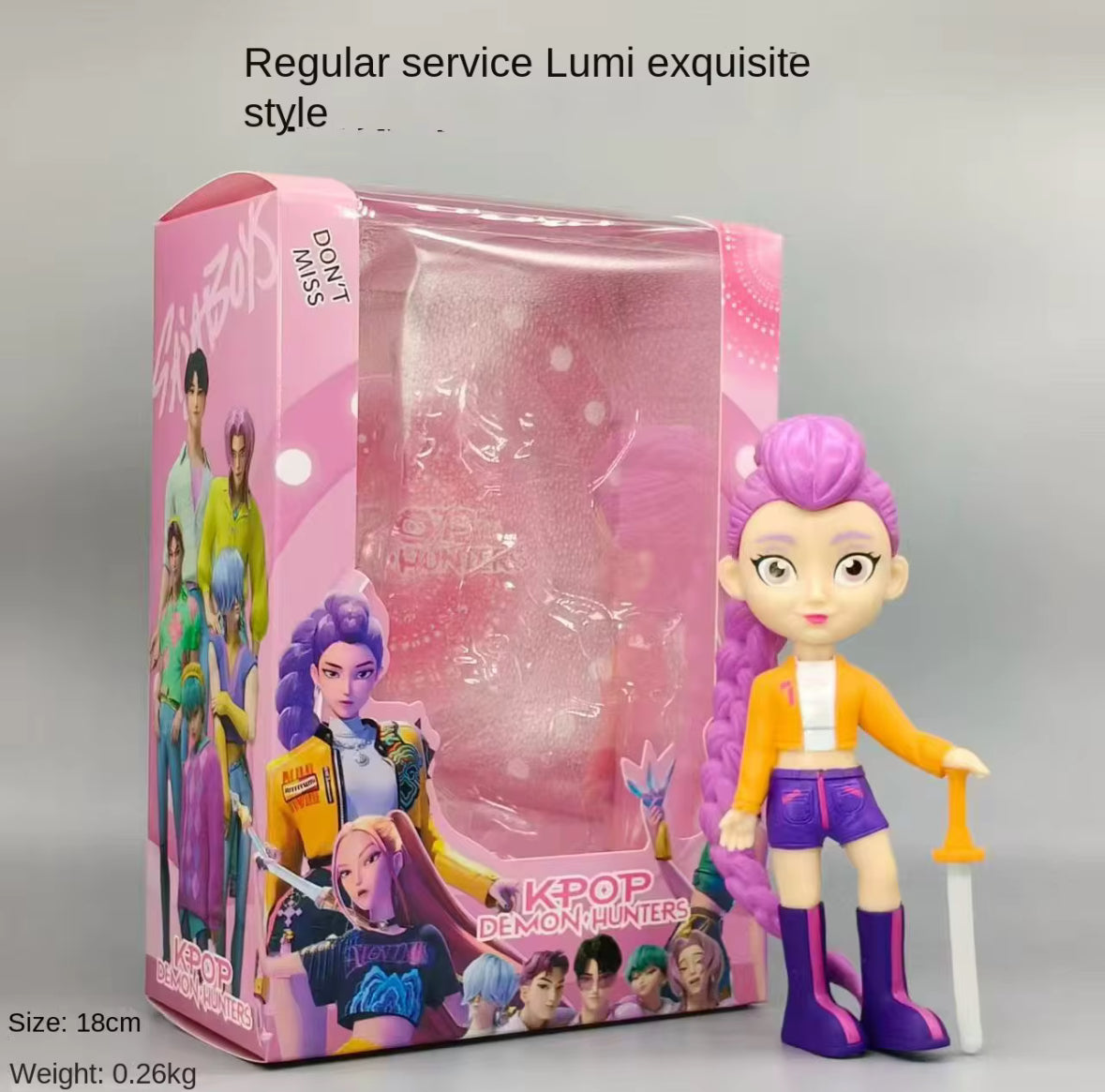 K-Pop colourful figure standing with a sword next to packaging.