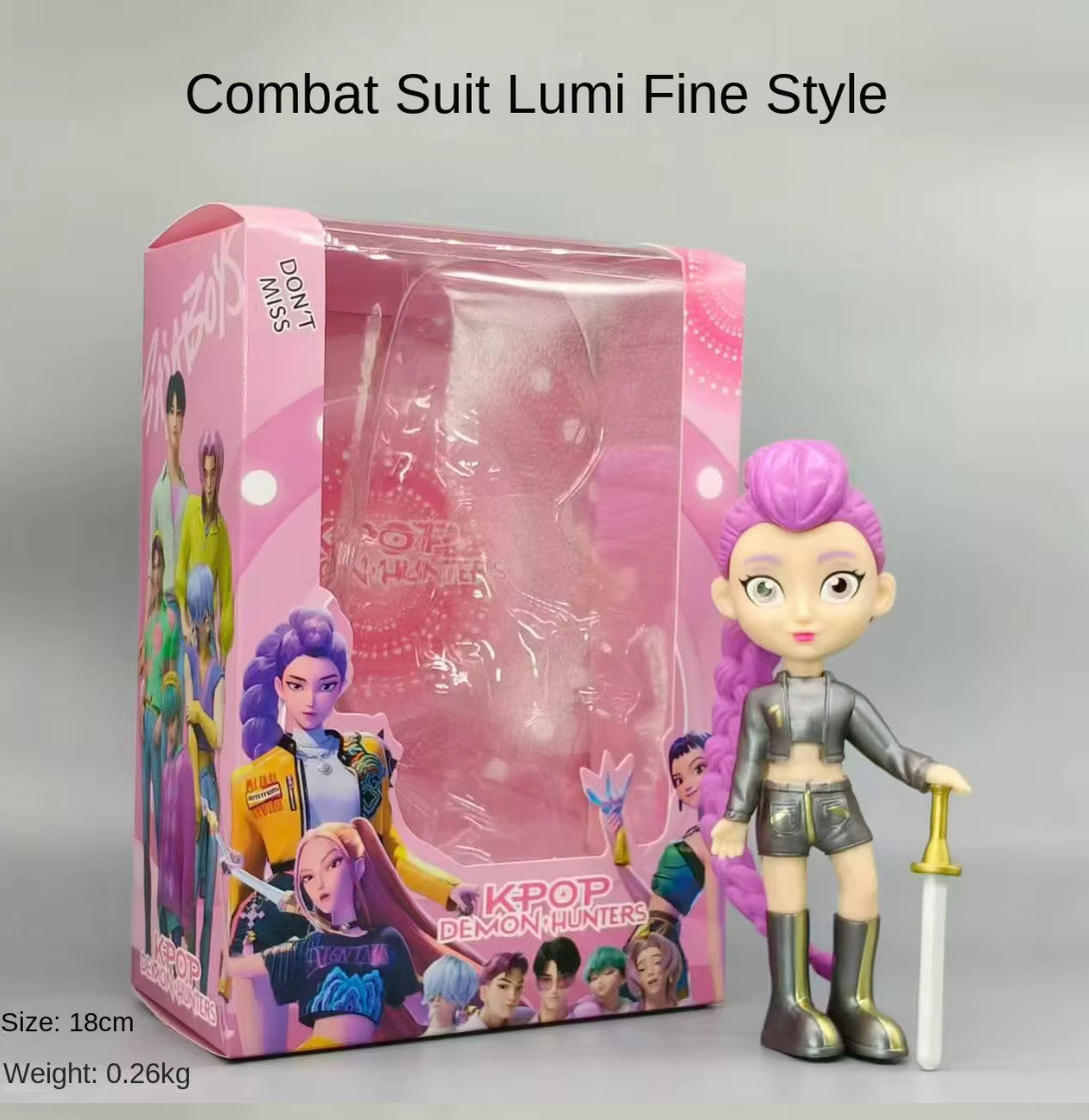 Toy figure with pink hair with metallic outfit an a sword next to its packaging on a grey background