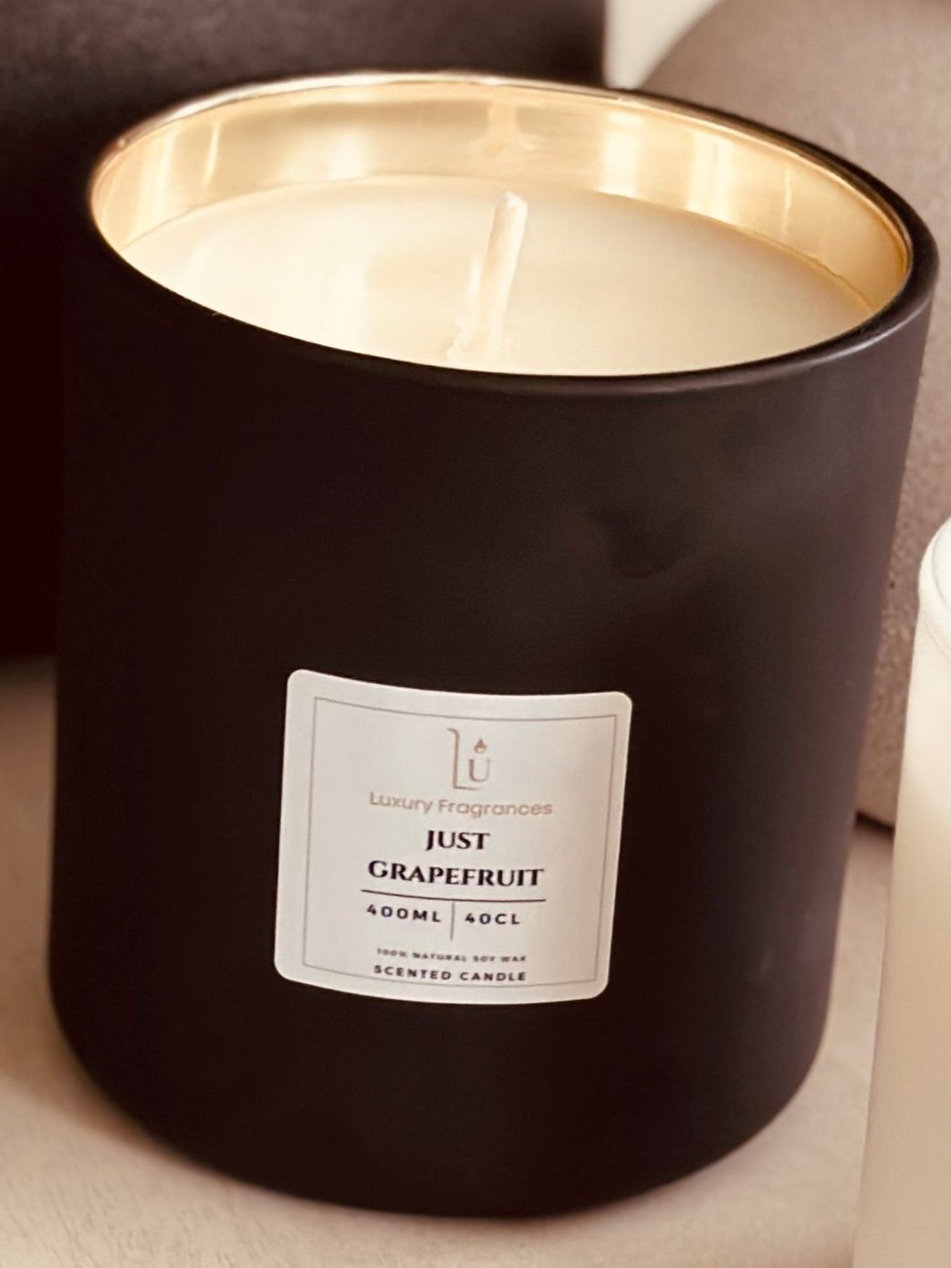 Elevate your home decor with our Matte Black Lux Scented Candle (Vogue). Experience the exquisite luxury of this home fragrance range.

Featuring a matte black design with a mercury gold inlay and black lid, that adds a touch of sophistication to any room. Indulge your senses with its captivating scent and create a welcoming ambiance for any occasion.