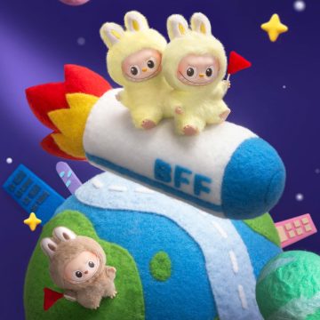 Toy plush with two cartoonish characters on a rocket, labeled 'BFF', against a purple background with stars.