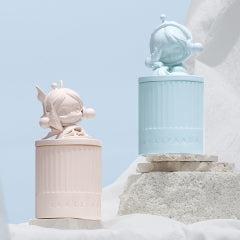 Two decorative Pop Mart candles on a stone ledge with a light blue sky background