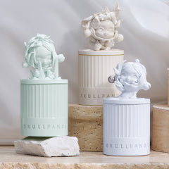 Decorative Pop Mart candles with classical designs on a neutral background