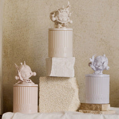 Decorative Pop Mart candles with sculptures on a textured surface